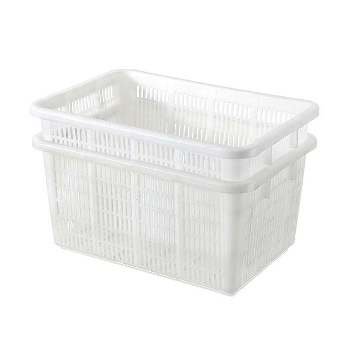 One white plastic crate nest into another.