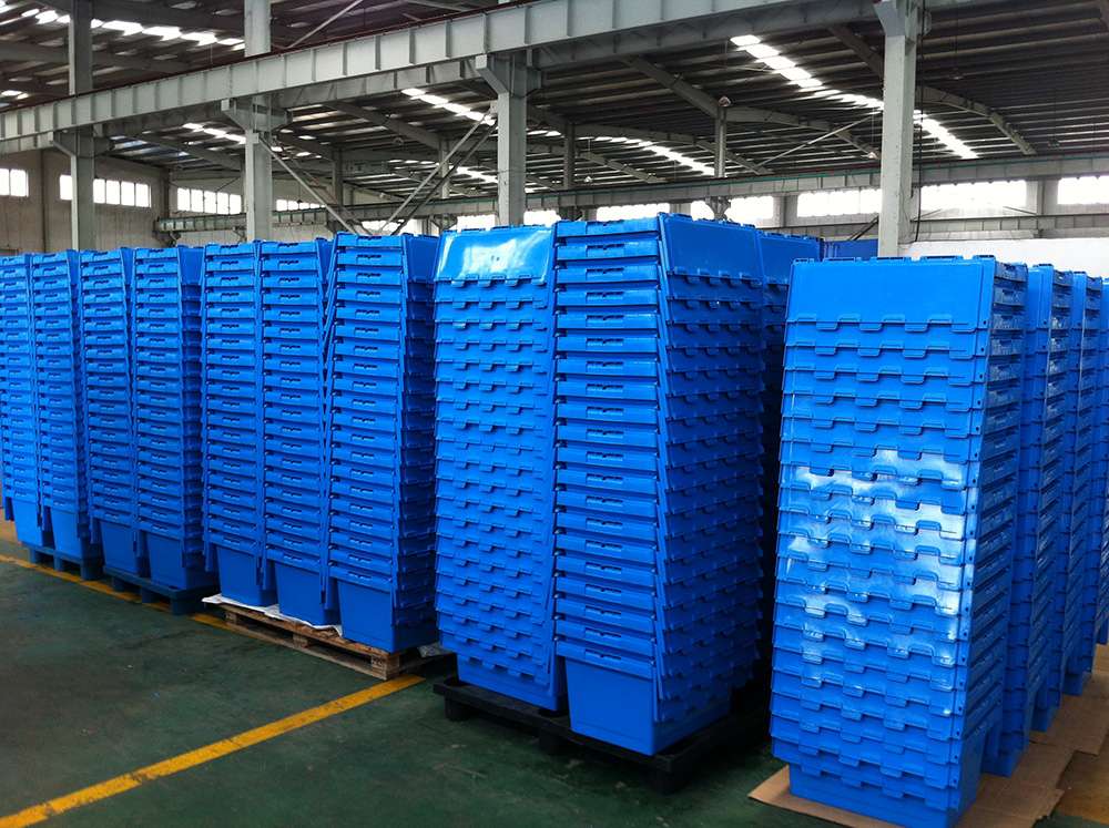 Nested blue plastic moving boxes in warehouse.
